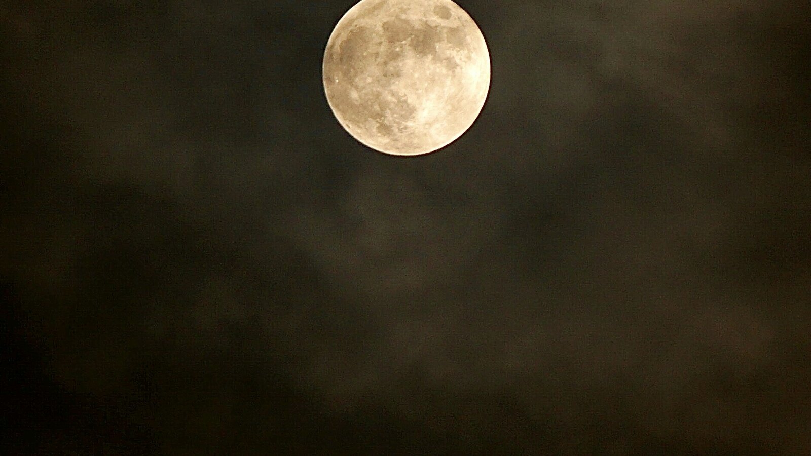 A full moon in a dark sky